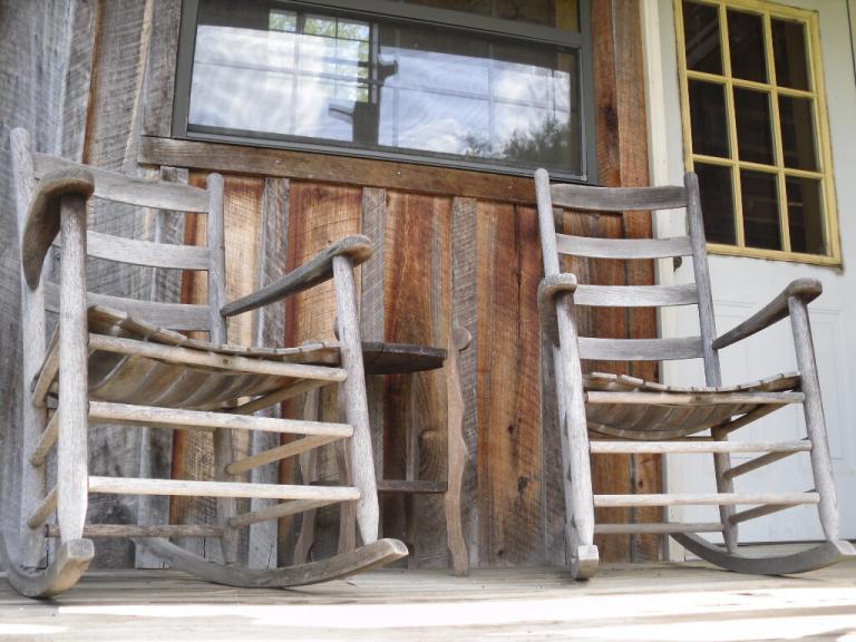 wood rocking chairs on rustic porch