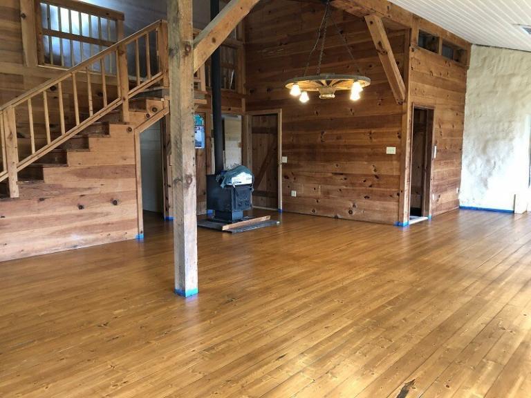 refinished floor at Strawbale Lodge with wood stove